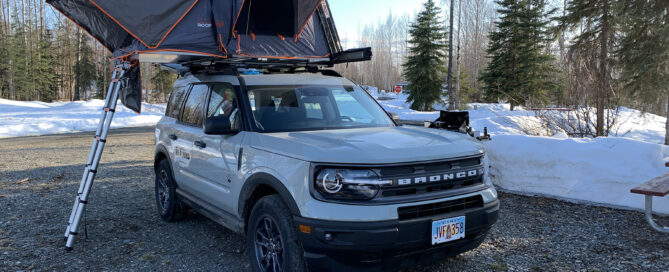 Spring camping in a Travel SUV with tent open and snow on the ground