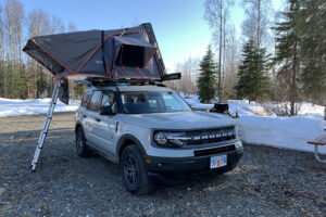 Spring camping trip in a Travel SUV, awning set up and snow on the ground