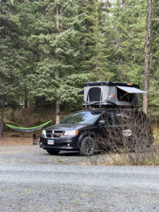 Travel Van with Tent Open and Hammock at Campsite