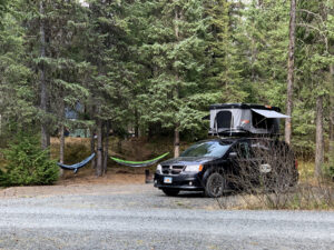 Travel Van with Tent Open and Hammock at Campsite